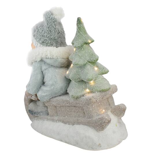 15" Beige & Green Lighted Boy on a Sled Christmas Decoration
